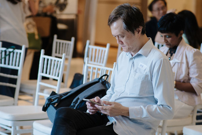 man-sitting-in-audience-at-clever-desk-event