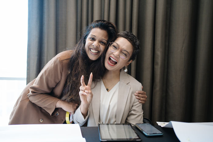 woman-seated-smiling-at-the-clever-desk-event